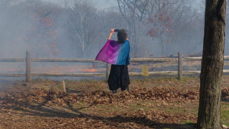 Person photographing the burn